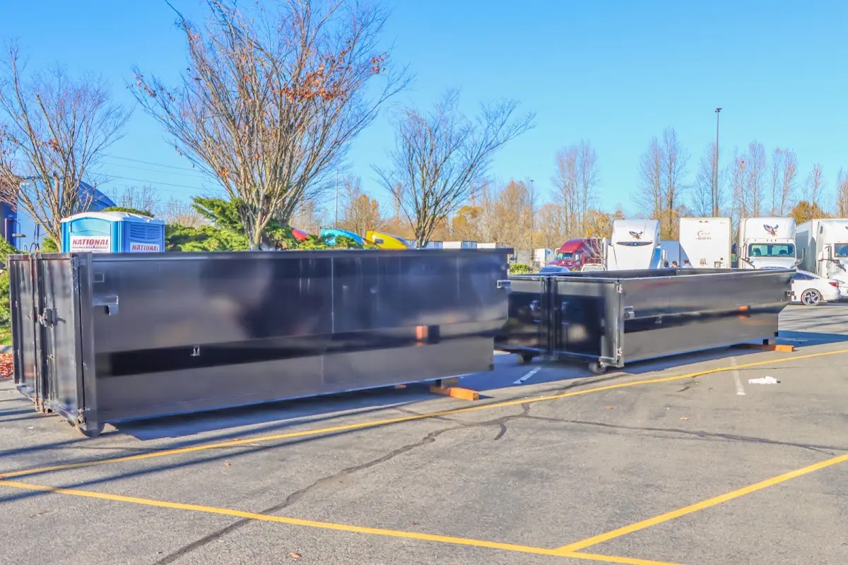 Professional dumpster rental service with roll-off container on residential driveway in Forestville